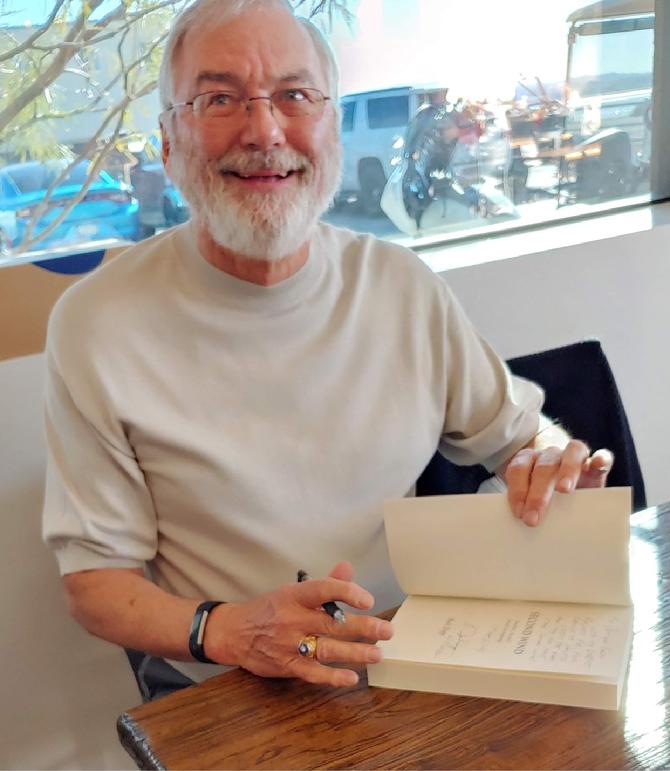 Buck Dopp signing copies of Second Wind